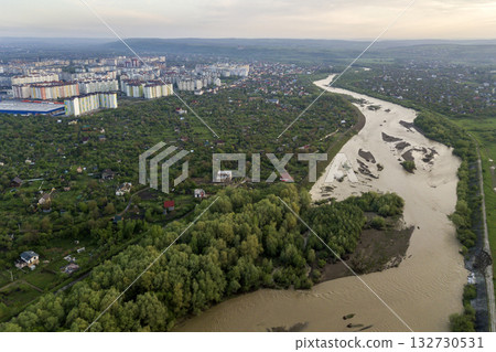 Aerial view of Ivano-Frankivsk city with residential area and suburb houses with a river in middle. Aerial view of Ivano-Frankivsk city with residential area and suburb houses with a river in middle. 132730531