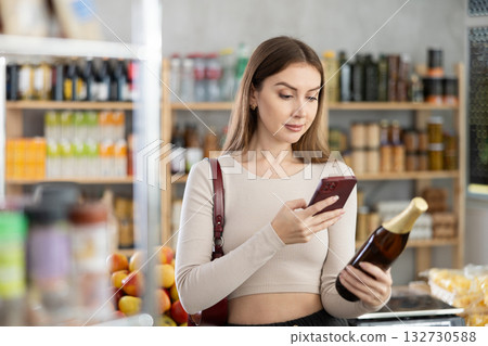 Young woman scanning qr code of beer 132730588