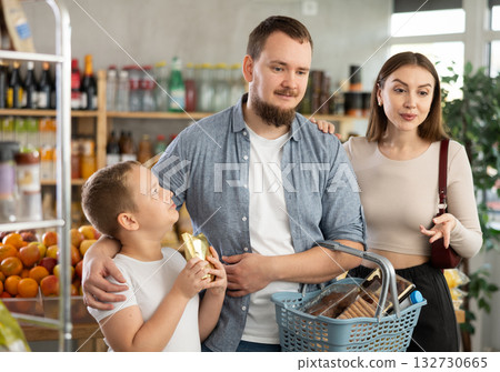 Man with wife and son shopping in grocery store Man with wife and son shopping in grocery store 132730665