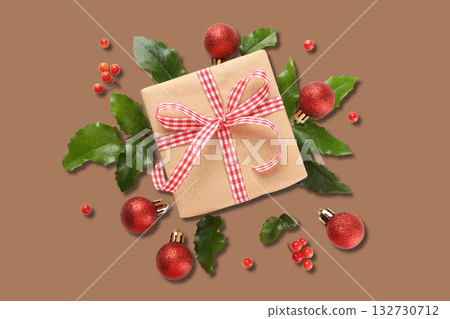 Gift box with ribbon among Christmas decor Gift box with ribbon among Christmas decor 132730712