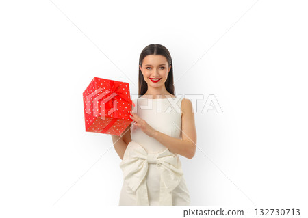 Smiling woman with a red polka dot gift box, isolated, PNG 132730713