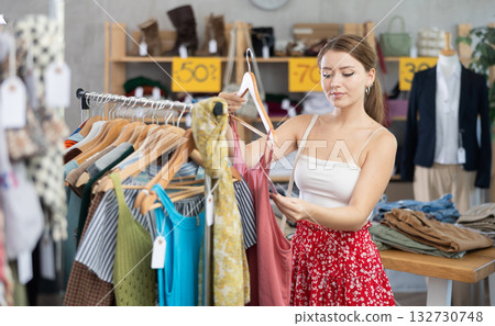 Woman standing in store and choosing clothes 132730748