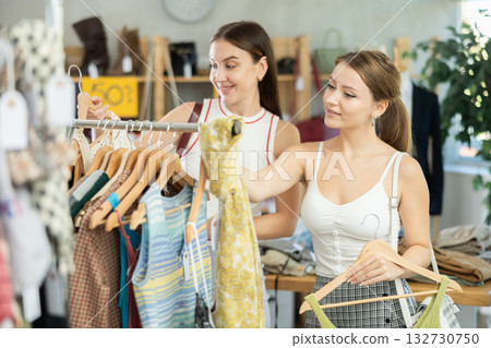 Two women choosing clothes in a store Two women choosing clothes in a store 132730750