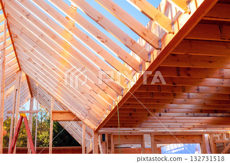 Workers are building wooden beams rafters roof frame in home construction. 132731518