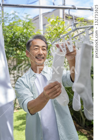 Senior man drying laundry 132731625