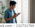 Happy Asian man drinking hot coffee in the morning using the phone 132731760