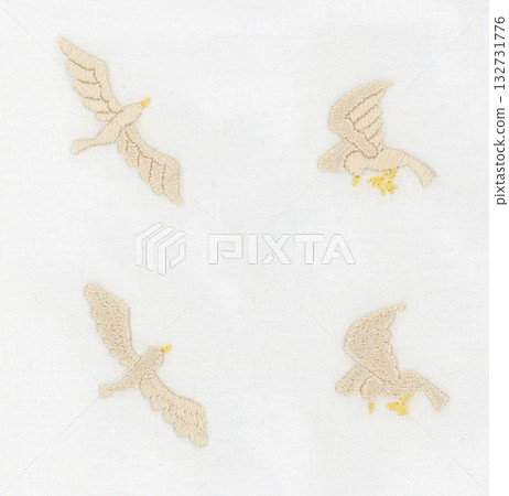 Four white birds embroidered in a natural style Four white birds embroidered in a natural style 132731776