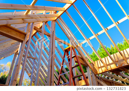 Workers are building wooden structure with beams joists roofing frame stick Workers are building wooden structure with beams joists roofing frame stick 132731823