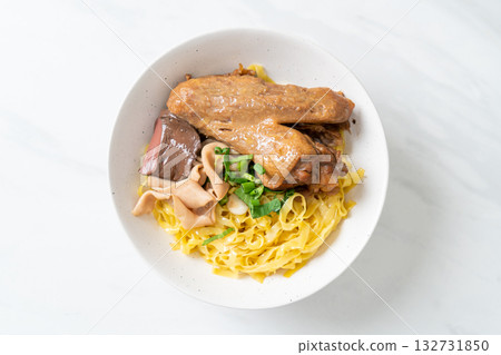 Egg noodles served dry with braised duck Egg noodles served dry with braised duck 132731850