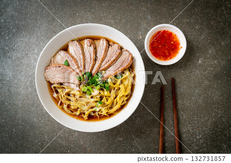 egg noodles with stewed duck in brown soup 132731857