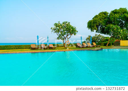 chair pool  or bed pool and umbrella around swimming pool with sea background 132731872
