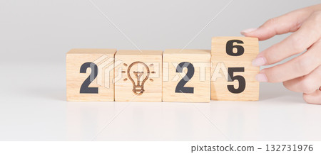 2025 year change to 2026 year block with lightbulb. Business Idea, Creative, Thinking, brainstorm, Goal, Resolution, strategy, plan, Action, change and New Year start concepts 132731976