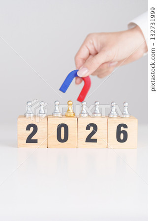 hand holding magnet and pulling man chess figure from the crowd employee with 2026 Year block. Human resource management, Recruitment, Teamwork, strategy, toxic people and leadership Concepts 132731999