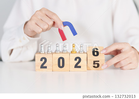 hand holding magnet and pulling man chess figure from the crowd employee with 2026 Year block. Human resource management, Recruitment, Teamwork, strategy, toxic people and leadership Concepts 132732013