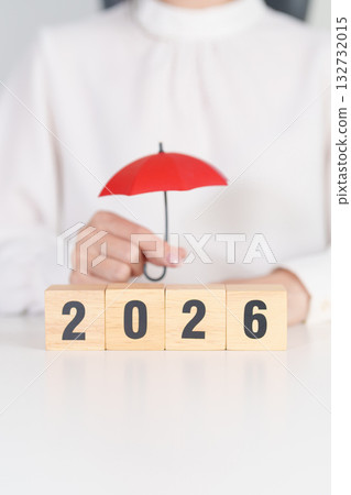 Happy New Year 2026 with hand holding red umbrella. Insurance, protection, safety and New year holiday Concepts 132732015