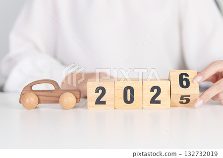 2025 end year to Happy New Year 2026 with Car model on table. Automobile Tax, Car Insurance, Financial, vehicle Repair and Maintenance and New Year concept 132732019