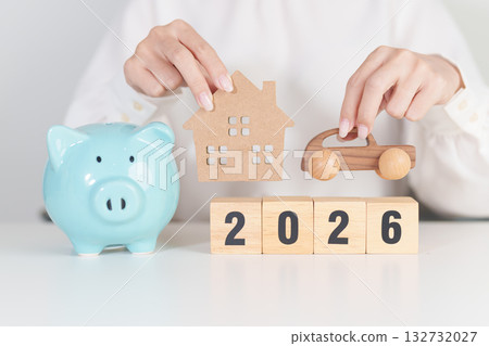 Happy New Year 2026 with car and Home model with coin stack. Car loan, Interest rate, real estate, house, Insurance, Financial, Repair, Tax, mortgage and Maintenance 132732027