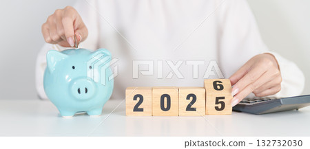 2025 end year to Happy New Year 2026 with piggy bank. Resolution, Goals, Plan, Action, Money Saving, Retirement fund, Pension, Investment and Financial concepts 132732030