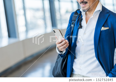 A middle-aged man operating a smartphone. 132732845