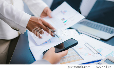 Business Team Analyzing Financial Data and Discussing Strategy Business Team Analyzing Financial Data and Discussing Strategy 132733176