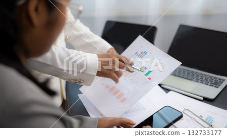 Business Team Discussing Financial Report and Data Analysis 132733177