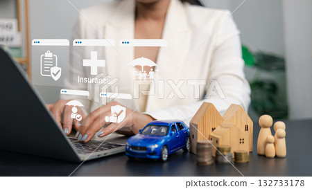 Businesswoman using laptop with digital insurance icon, family protection, car and house finance concept Businesswoman using laptop with digital insurance icon, family protection, car and house finance concept 132733178