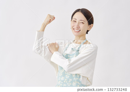 Woman wearing an apron, motivated gesture, white background 132733248