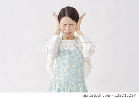 一位女士戴著圍裙遮住耳朵，白色背景 132733257