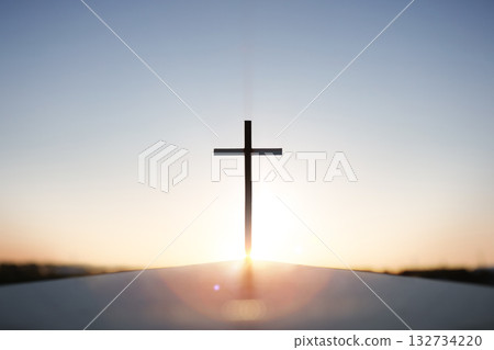Rising New Year sunrise and the Holy Cross of Jesus Christ, with bright sky and shining sun in the background Rising New Year sunrise and the Holy Cross of Jesus Christ, with bright sky and shining sun in the background 132734220