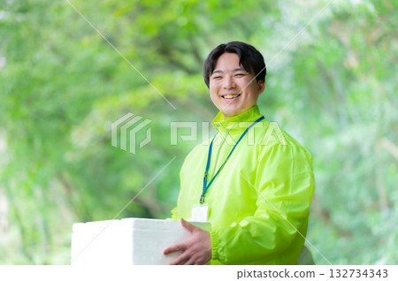 Delivery person with a cooler bag Delivery person with a cooler bag 132734343