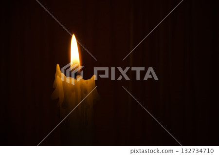Single Candle Flame in Darkness Warm Glow, Melting Wax, Quiet Mood, Intimate Lighting Single Candle Flame in Darkness Warm Glow, Melting Wax, Quiet Mood, Intimate Lighting 132734710
