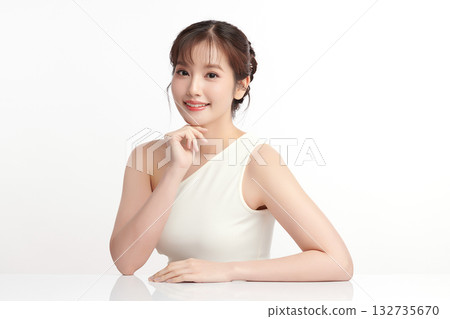 A beautiful young Asian woman with clean, fresh skin against a white background. Skincare, facial treatment, cosmetology, beauty, and spa. An elegant portrait of an Asian woman. 132735670