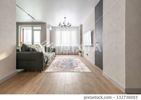 Bright Living Room with Green Sofa and Large Window 132736083