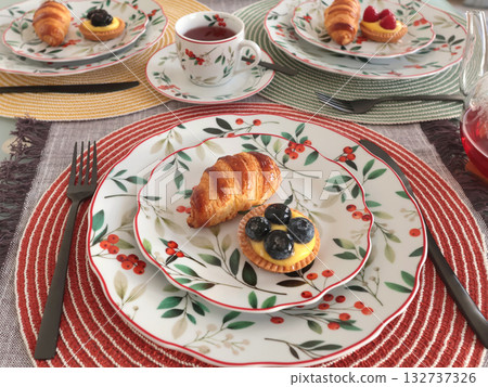Table setting with bright tableware, berries, and twigs. Dessert on plate. Aesthetics and lifestyle. Home design.  132737326