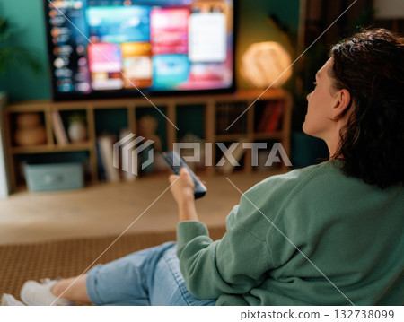 woman watching TV at home woman watching TV at home 132738099