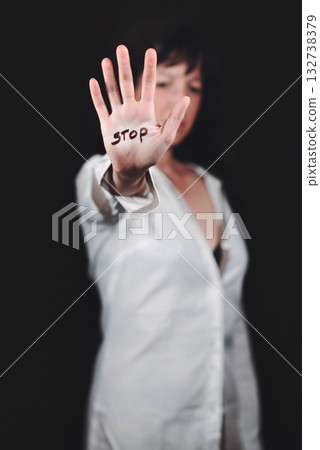 Young woman with hand writing stop 132738379