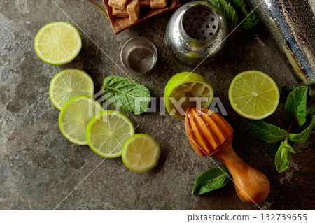 Wooden citrus squeezer, shaker, and ingredients for making summer refreshing drinks. Wooden citrus squeezer, shaker, and ingredients for making summer refreshing drinks. 132739655