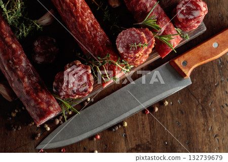 Sliced dry cured sausages with peppercorns, thyme, rosemary, and garlic. 132739679
