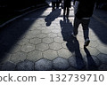 Shadows of people stretching across the hexagonal tiled sidewalk - City snapshots Shadows of people stretching across the hexagonal tiled sidewalk - City snapshots 132739710