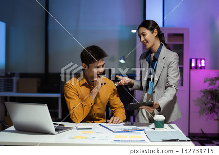 Business team analyzing data with laptops and graphs in office. Business team analyzing data with laptops and graphs in office. 132739715