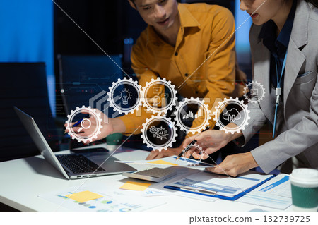 project manager working overtime on startup planning, updating progress milestones, and collaborating with investors for business success. 132739725