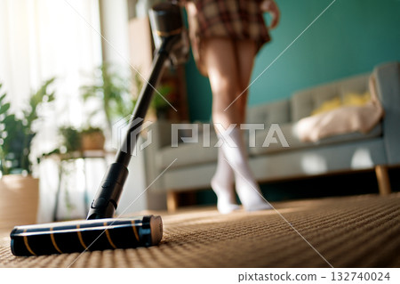 woman vacuuming floor 132740024