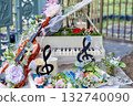 A piano and violin decorated with roses and a decorative table that gives off a musical vibe 132740090