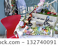 A piano and violin decorated with roses and a decorative table that gives off a musical vibe 132740091
