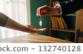 Real estate agent gives house keys to new homeowner 132740128