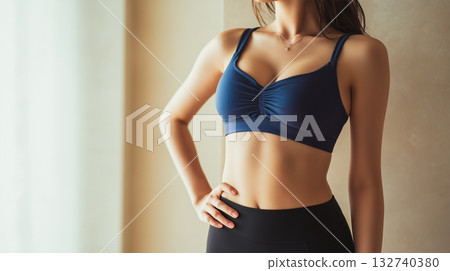 A woman shows her core in a sports outfit A woman shows her core in a sports outfit 132740380