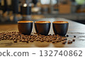Coffee cups with latte art surrounded by roasted beans 132740862
