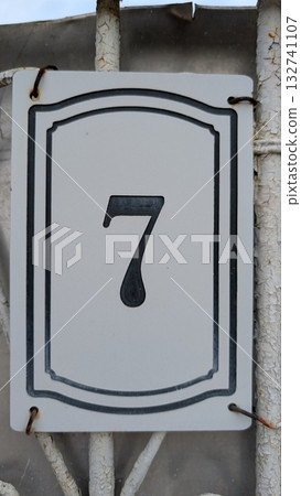 House Number Sign Featuring an Elegant and Distinctive Design with Number 7 Displayed 132741107