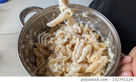 Delicious Creamy Pasta Dish Cooked in a Beautiful Stainless Steel Pot Ready to Enjoy Delicious Creamy Pasta Dish Cooked in a Beautiful Stainless Steel Pot Ready to Enjoy 132741124