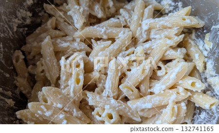 Enjoy a rich, creamy Penne Pasta Dish, topped with melting cheese, perfect for gatherings Enjoy a rich, creamy Penne Pasta Dish, topped with melting cheese, perfect for gatherings 132741165